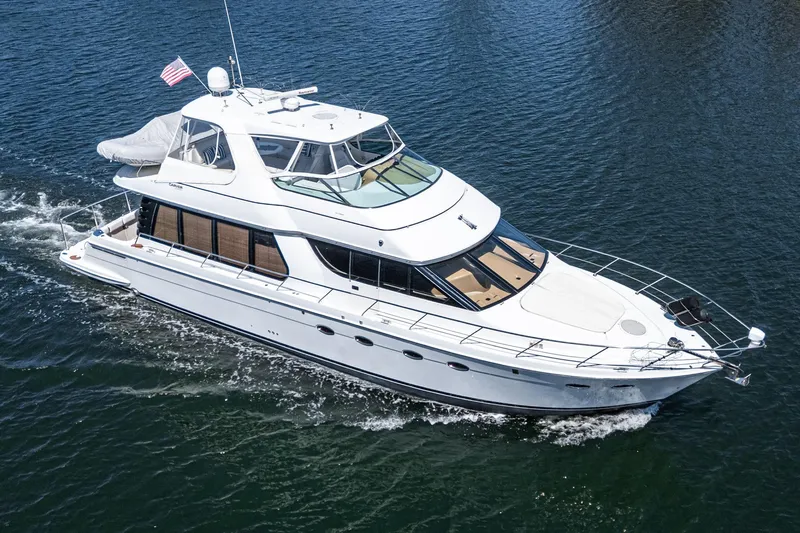  Yacht Photos Pics 2003 Carver 570 Voyager Pilothouse yacht cruising on open water.