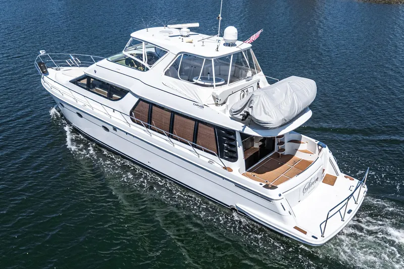  Yacht Photos Pics 2003 Carver 570 Voyager Pilothouse yacht cruising on open water.