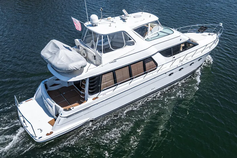  Yacht Photos Pics 2003 Carver 570 Voyager Pilothouse yacht cruising on open water.