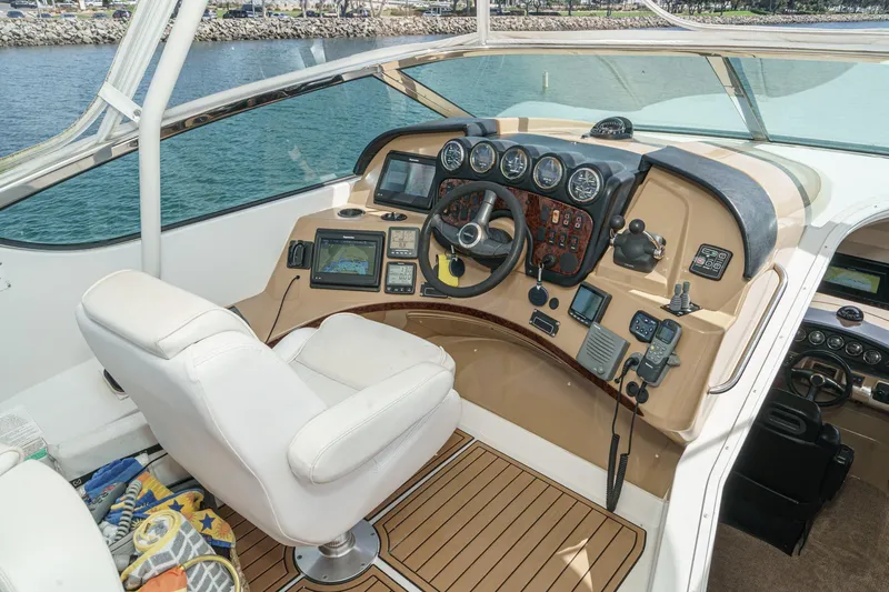 Yacht Photos Pics Pilothouse of 2003 Carver 570 Voyager, featuring navigation instruments and a comfortable captain's chair.