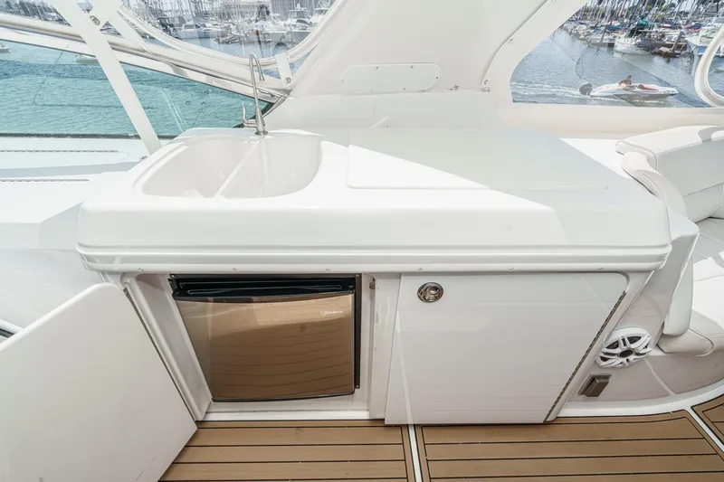  Yacht Photos Pics 2003 Carver 570 Voyager Pilothouse yacht interior with sink and mini fridge.