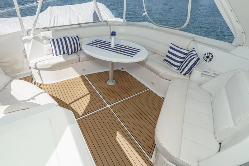  Yacht Photos Pics Luxurious 2003 Carver 570 Voyager Pilothouse yacht interior with elegant seating and striped cushions.