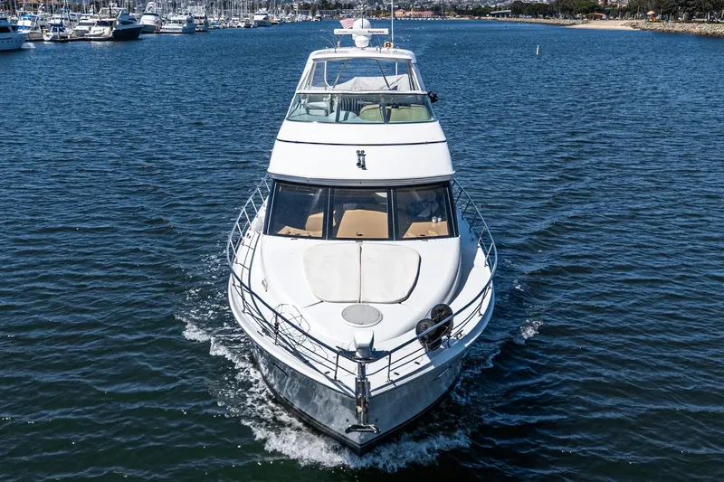  Yacht Photos Pics 2003 Carver 570 Voyager Pilothouse yacht cruising in a marina.