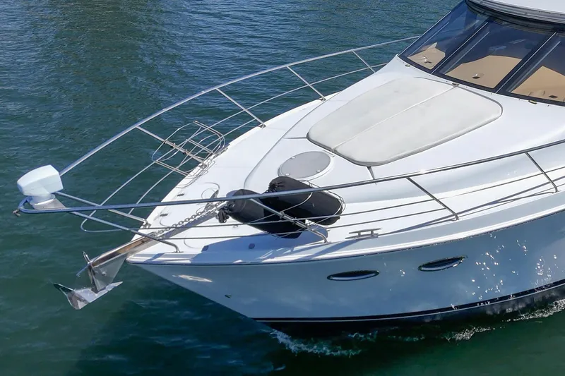  Yacht Photos Pics 2003 Carver 570 Voyager Pilothouse yacht on water, showcasing sleek design and bow features.