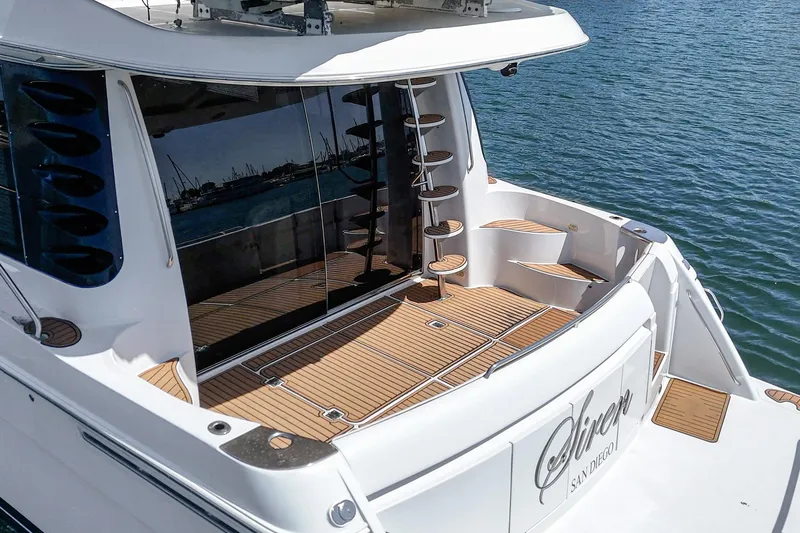  Yacht Photos Pics 2003 Carver 570 Voyager Pilothouse yacht with teak deck, docked in sunny marina.