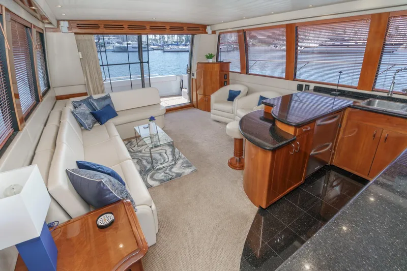  Yacht Photos Pics Luxurious interior of 2003 Carver 570 Voyager Pilothouse yacht with elegant seating and kitchen area.