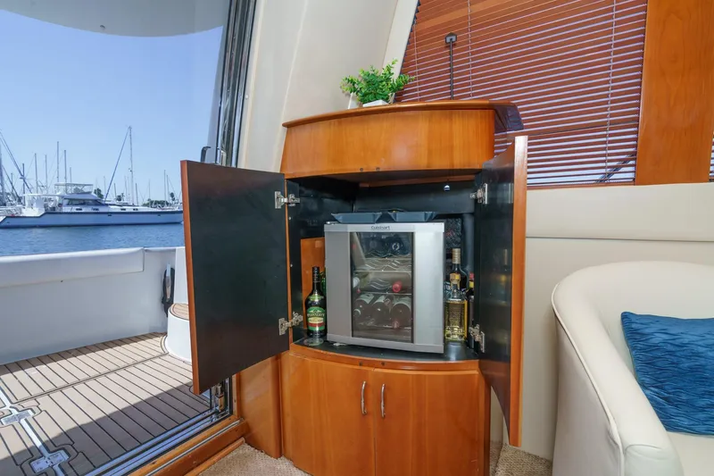  Yacht Photos Pics Luxurious 2003 Carver 570 Voyager Pilothouse yacht interior with wine cabinet and scenic marina view.