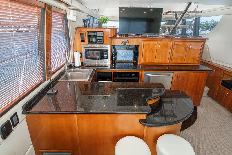  Yacht Photos Pics Luxurious kitchen interior of 2003 Carver 570 Voyager Pilothouse yacht with modern appliances.