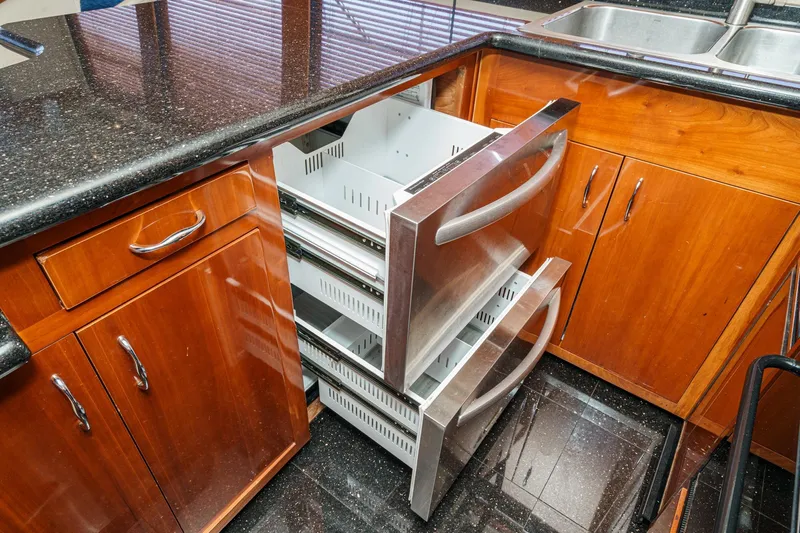  Yacht Photos Pics Kitchen drawers in 2003 Carver 570 Voyager Pilothouse, featuring sleek wood cabinetry.