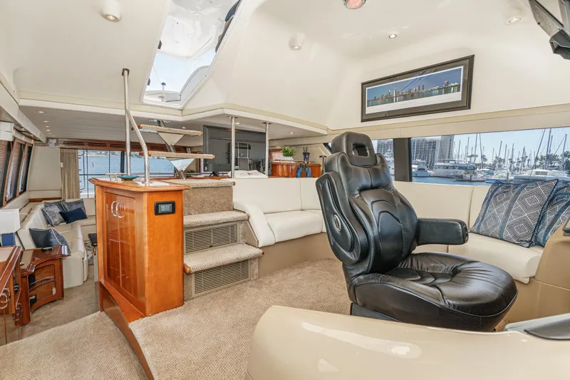  Yacht Photos Pics Luxurious interior of 2003 Carver 570 Voyager Pilothouse with leather seating and elegant decor.