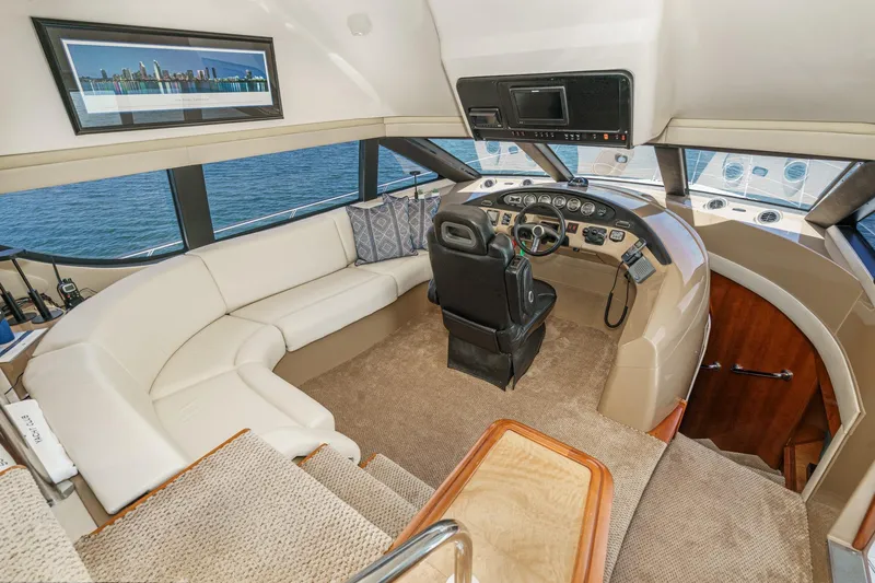  Yacht Photos Pics Luxurious 2003 Carver 570 Voyager Pilothouse interior with helm and seating area.