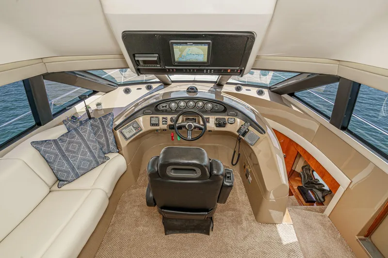  Yacht Photos Pics 2003 Carver 570 Voyager Pilothouse interior with helm, seating, and navigation equipment.