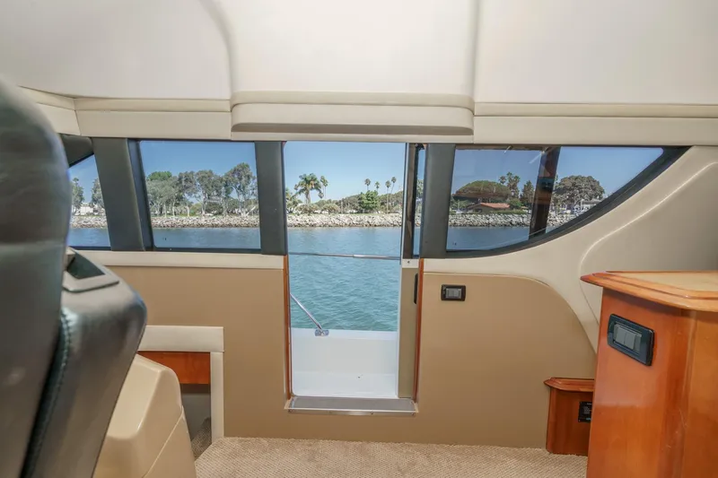  Yacht Photos Pics Interior view of 2003 Carver 570 Voyager Pilothouse with scenic waterway through windows.