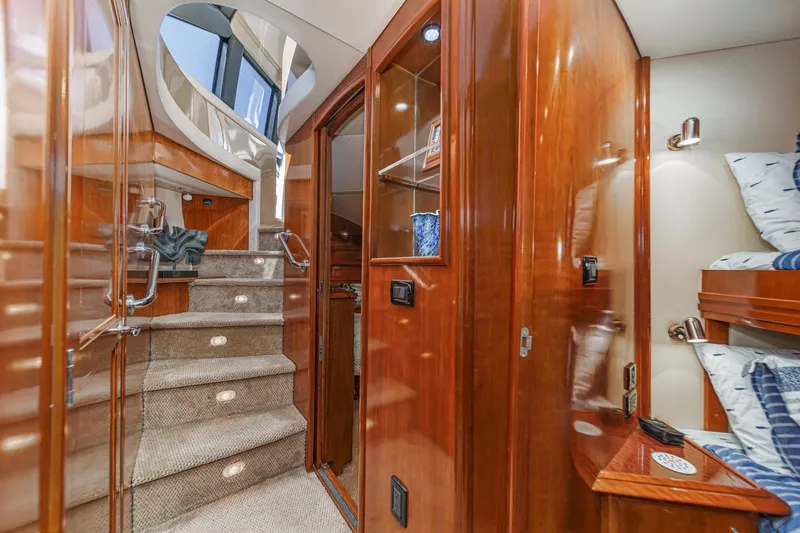  Yacht Photos Pics Luxurious interior of 2003 Carver 570 Voyager Pilothouse with elegant wood finishes and cozy bunks.