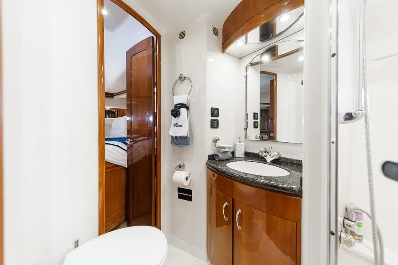  Yacht Photos Pics Luxurious bathroom in 2003 Carver 570 Voyager Pilothouse yacht, featuring elegant wood cabinetry.