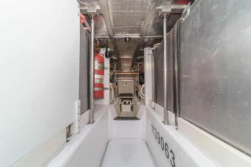  Yacht Photos Pics Engine room of 2003 Carver 570 Voyager Pilothouse, featuring fire extinguisher and metallic surfaces.