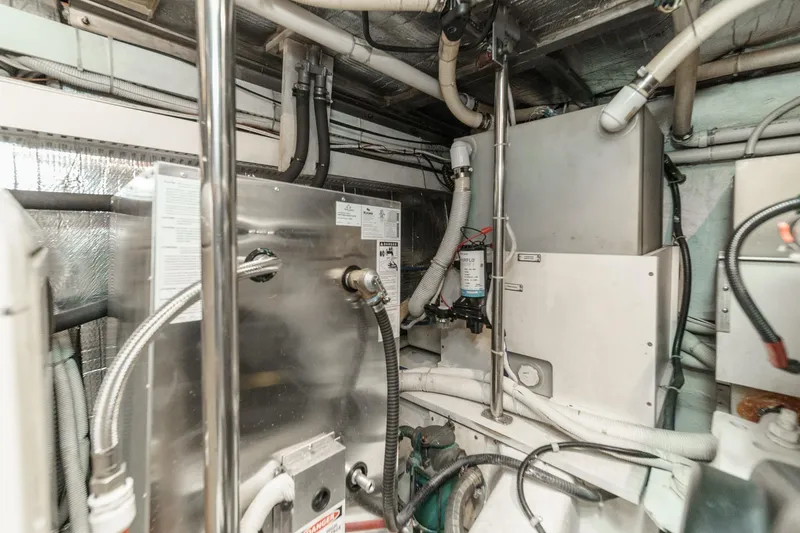  Yacht Photos Pics Engine room of 2003 Carver 570 Voyager Pilothouse with pipes and machinery.