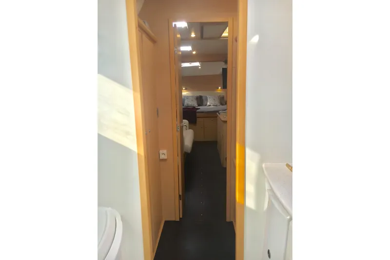 Rewind Yacht Photos Pics Interior view of 2007 Lagoon 440 yacht, featuring a narrow hallway and cozy cabin.