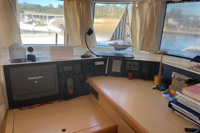 Rewind Yacht Photos Pics Interior of 2007 Lagoon 440 yacht with navigation equipment and scenic window view.