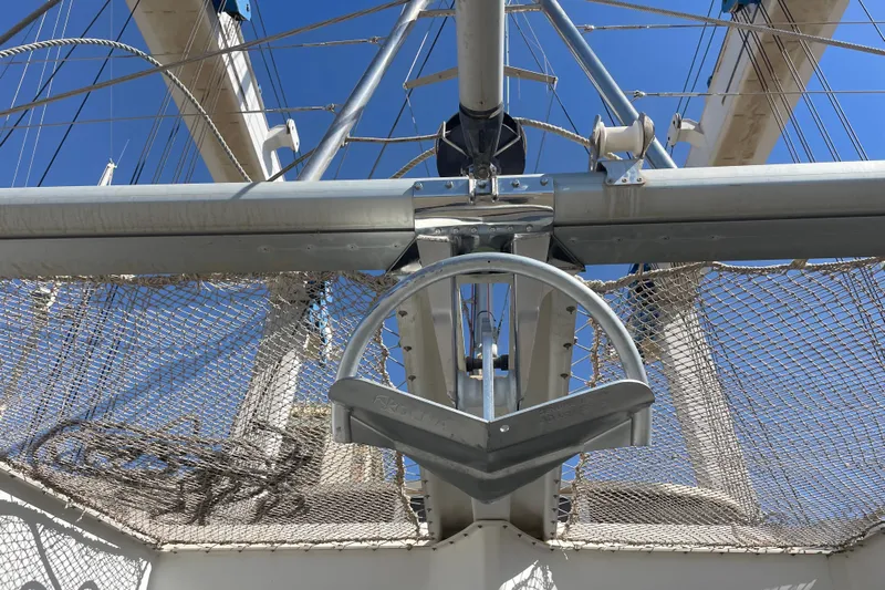 Rewind Yacht Photos Pics Anchor and rigging on a 2007 Lagoon 440 catamaran under clear blue sky.