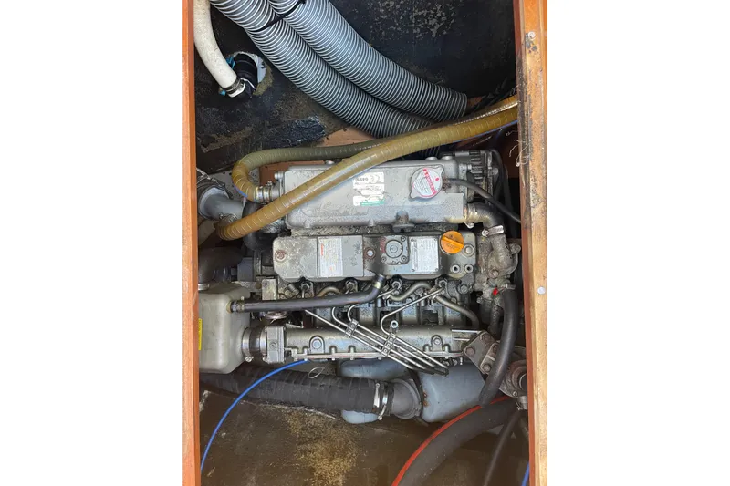 Rewind Yacht Photos Pics Engine compartment of a 2007 Lagoon 440 catamaran, showing hoses and mechanical components.