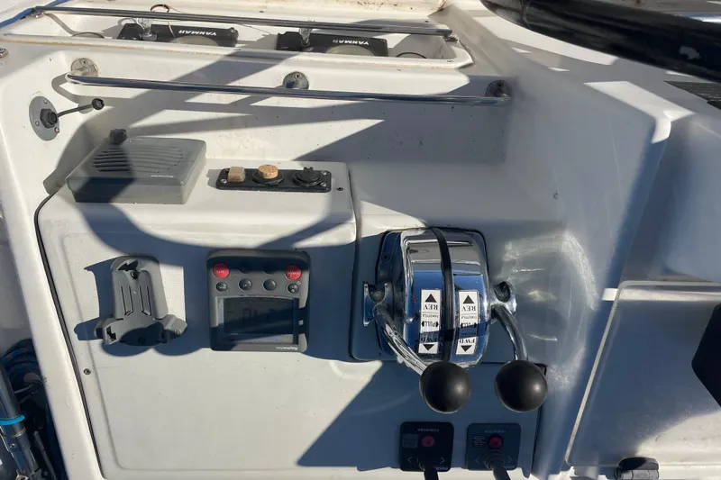 Rewind Yacht Photos Pics Control panel of a 2007 Lagoon 440 catamaran with dual throttle levers and navigation instruments.