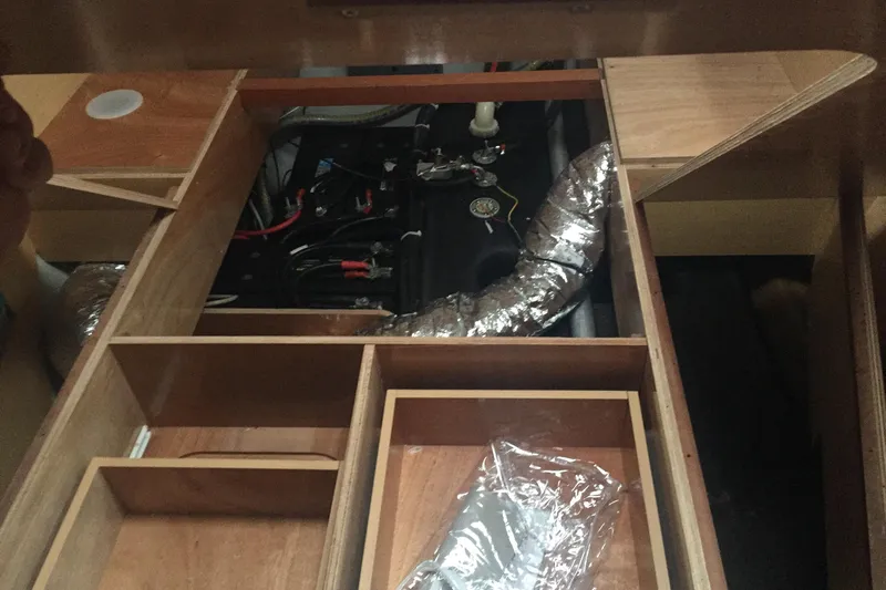 Rewind Yacht Photos Pics Engine compartment of a 2007 Lagoon 440 catamaran with visible wiring and ductwork.