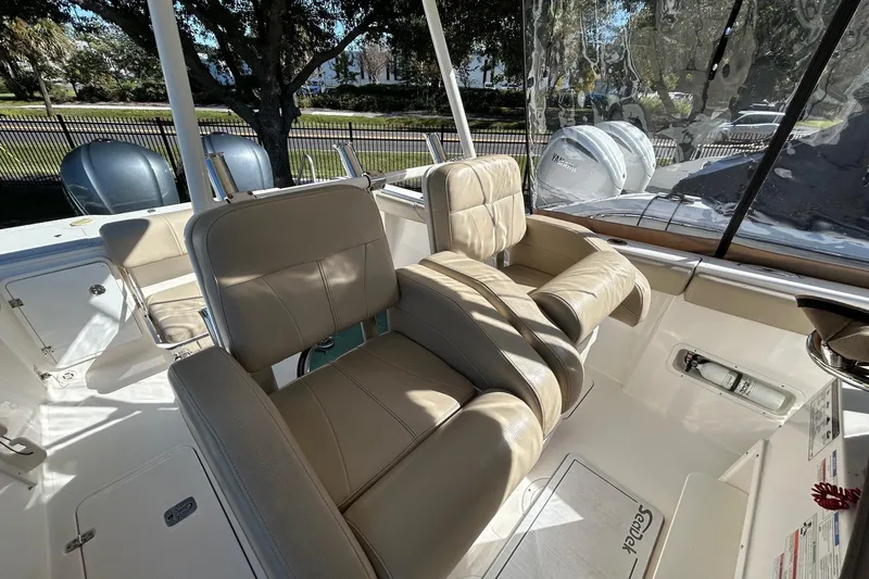  Yacht Photos Pics 2015 Pursuit C 280 Center Console boat interior with beige seating and dual engines.