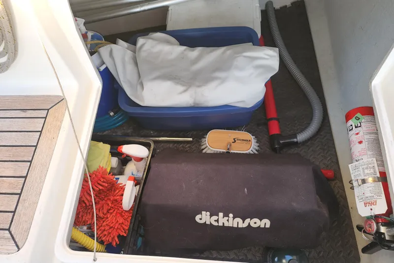 Danza Yacht Photos Pics Storage compartment on a 2007 Hanse 400e yacht with cleaning supplies and equipment.