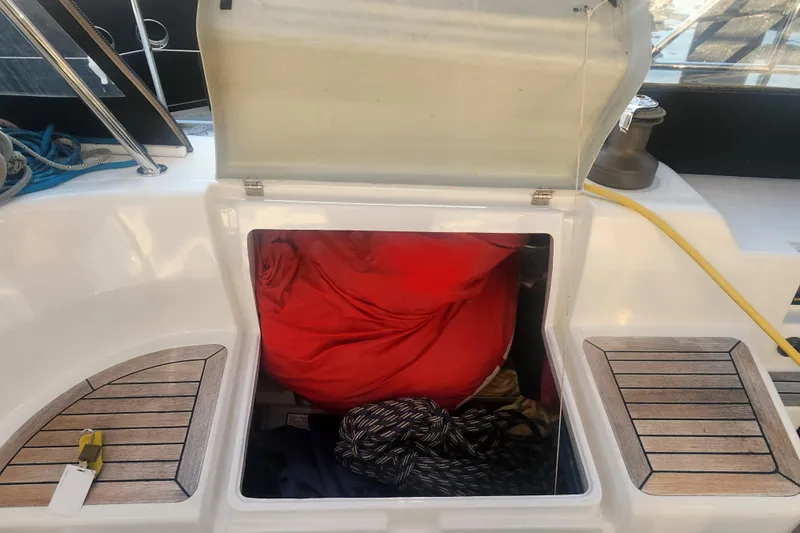 Danza Yacht Photos Pics Open storage compartment on 2007 Hanse 400e sailboat with ropes and red fabric.