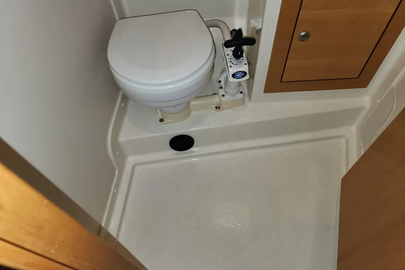 Danza Yacht Photos Pics Compact bathroom in 2007 Hanse 400e yacht with toilet and wooden cabinet.