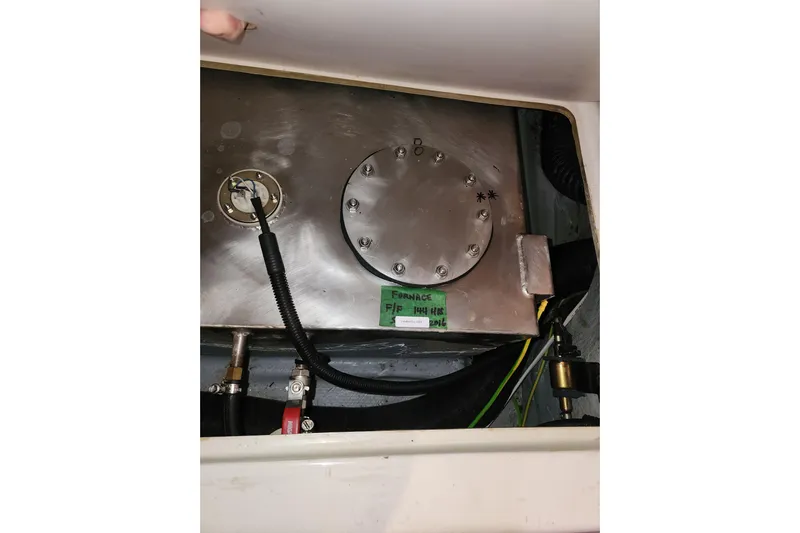 Danza Yacht Photos Pics Engine compartment of a 2007 Hanse 400e sailboat, showing fuel tank and connections.