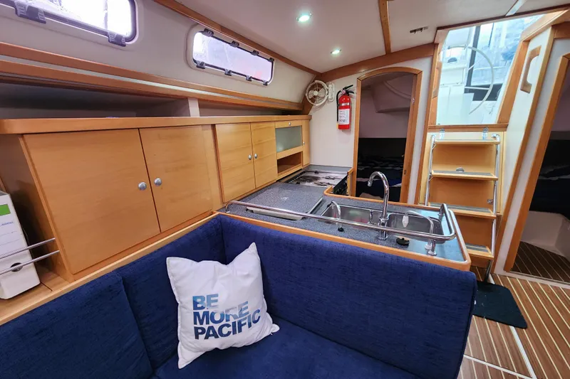 Danza Yacht Photos Pics Interior of 2007 Hanse 400e yacht with kitchen, seating, and wooden cabinetry.