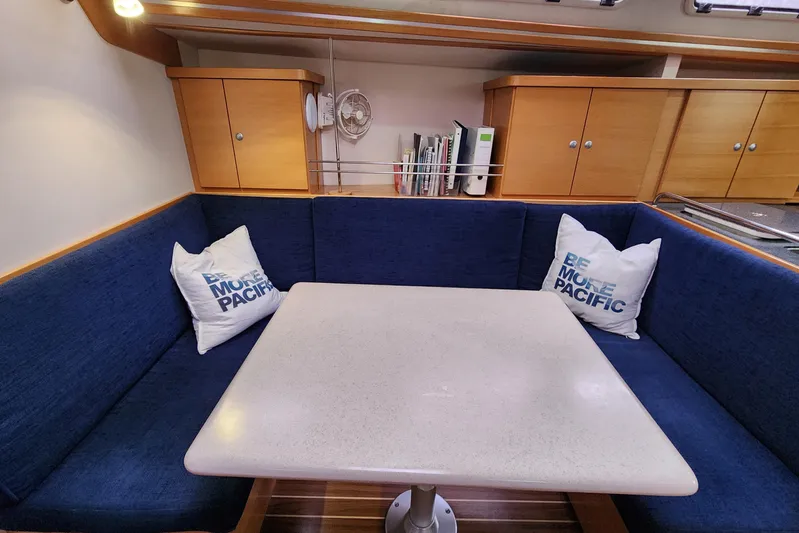 Danza Yacht Photos Pics Cozy interior of 2007 Hanse 400e yacht with blue seating and table.