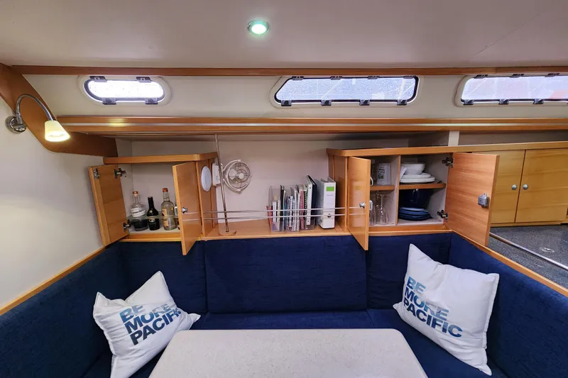 Danza Yacht Photos Pics Interior of 2007 Hanse 400e yacht with blue seating, open cabinets, and nautical decor.