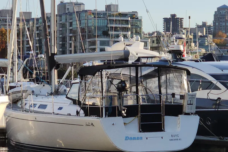 Danza Yacht Photos Pics Sailboat Hanse 400e, 2007 model, docked in a marina with cityscape background.