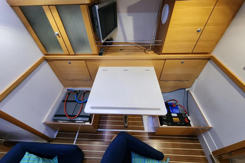 Danza Yacht Photos Pics Interior of 2007 Hanse 400e yacht with table, storage, and electrical components.