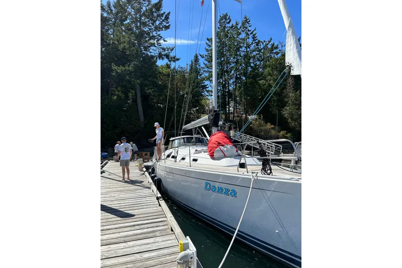 Danza Yacht Photos Pics 2007 Hanse 400e sailboat "Danza" docked with people on deck, surrounded by trees.