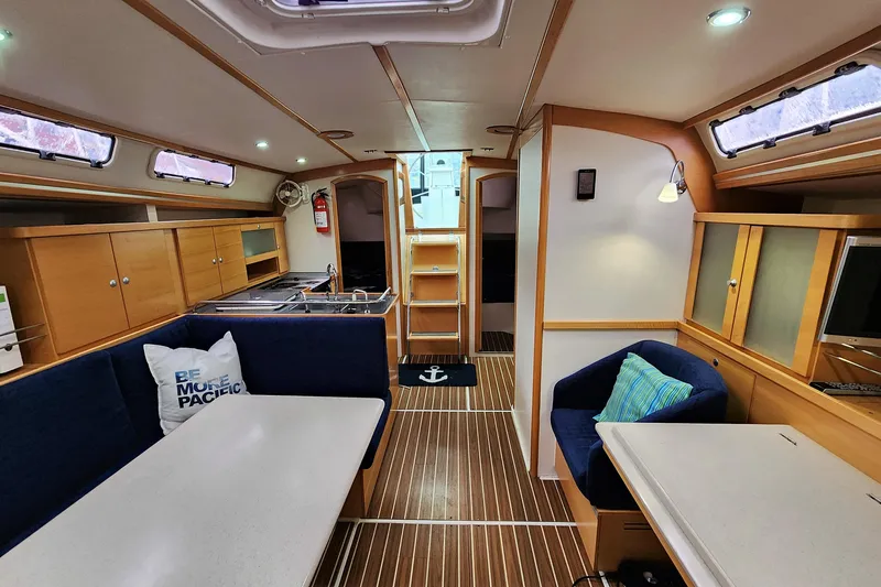 Danza Yacht Photos Pics 2007 Hanse 400e yacht interior with modern kitchen, seating, and wooden flooring.