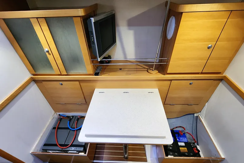 Danza Yacht Photos Pics Interior of 2007 Hanse 400e yacht with wooden cabinets and a foldable table.