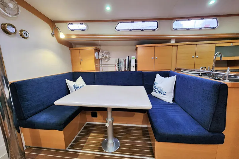 Danza Yacht Photos Pics 2007 Hanse 400e yacht interior with blue seating and dining table.