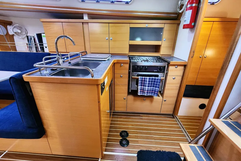 Danza Yacht Photos Pics Interior of 2007 Hanse 400e yacht kitchen with wooden cabinetry and modern appliances.