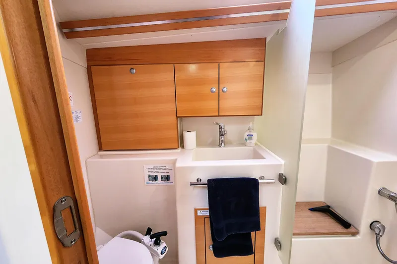 Danza Yacht Photos Pics 2007 Hanse 400e yacht bathroom with wooden cabinets and modern fixtures.