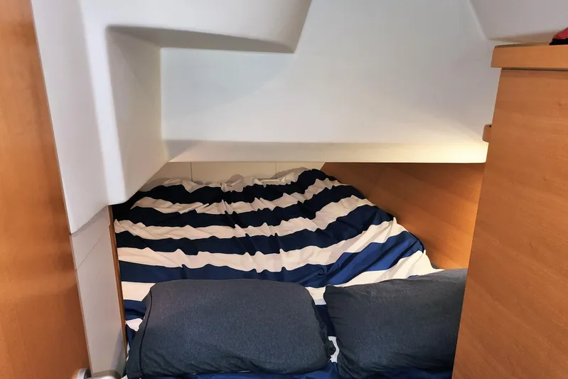 Danza Yacht Photos Pics Cozy cabin interior of 2007 Hanse 400e yacht with striped bedding and pillows.