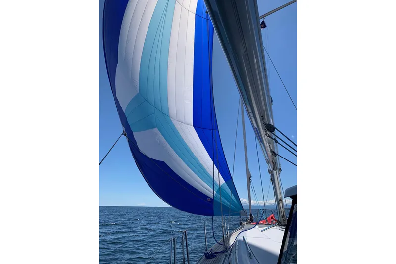 Danza Yacht Photos Pics Sailing on a 2007 Hanse 400e with a vibrant blue and white spinnaker.