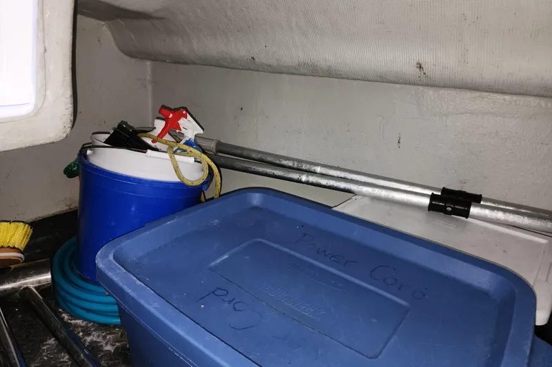 Danza Yacht Photos Pics Storage area in a 2007 Hanse 400e yacht with cleaning supplies and equipment.