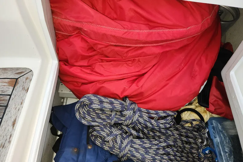 Danza Yacht Photos Pics Storage compartment on a 2007 Hanse 400e yacht with red sail and coiled rope.