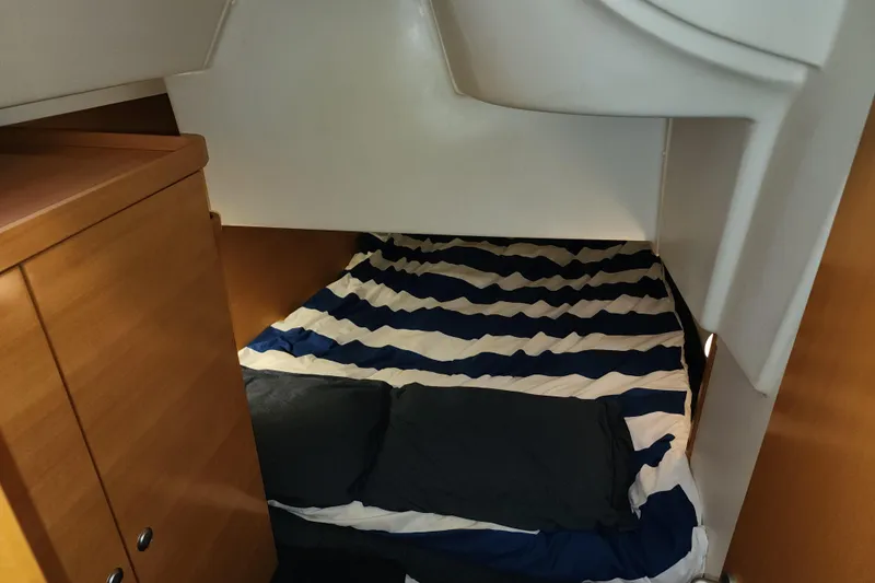 Danza Yacht Photos Pics Cozy cabin interior of 2007 Hanse 400e sailboat with striped bedding.