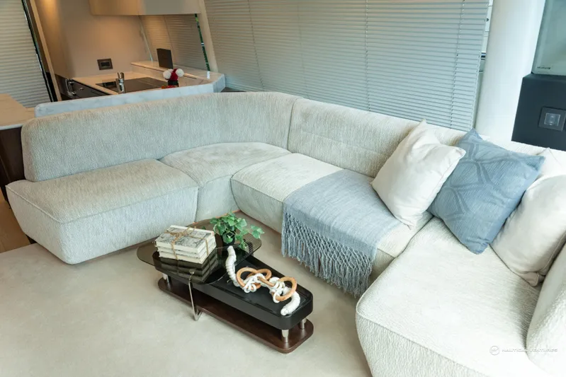 Fairline Phantom Yacht Photos Pics Luxurious interior of 2023 Fairline Phantom 65 yacht with elegant L-shaped sofa.