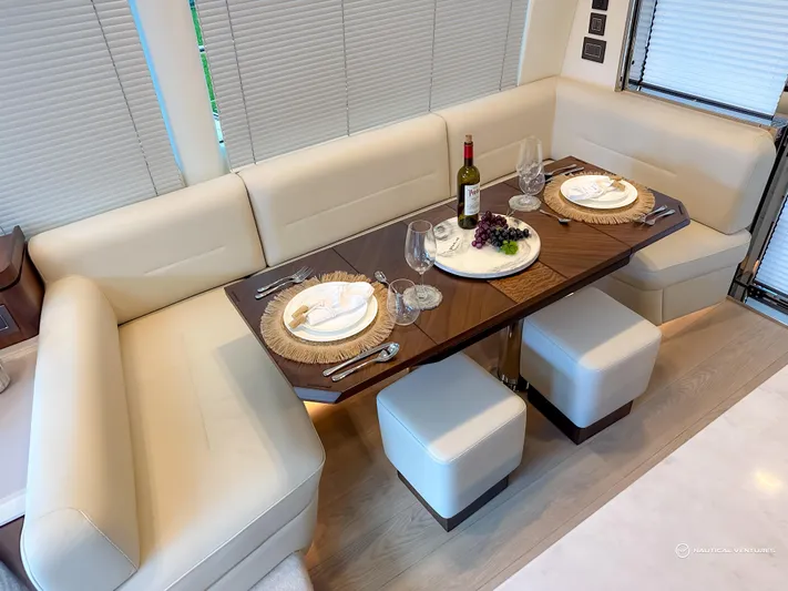 Fairline Phantom Yacht Photos Pics Luxurious dining area in 2023 Fairline Phantom 65 yacht with elegant table setting.